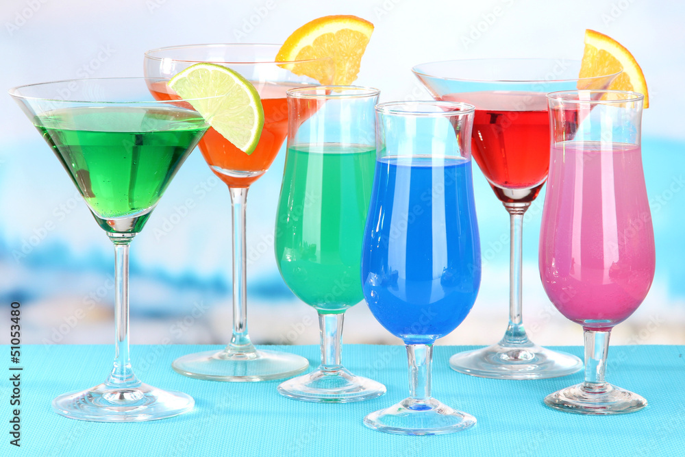 Glasses of cocktails on table near pool Glasses of cocktails on table near pool