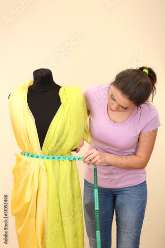 Beautiful young dressmaker ...