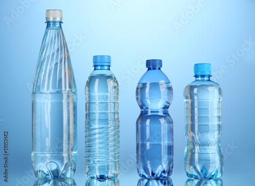 Different water bottles on blue background