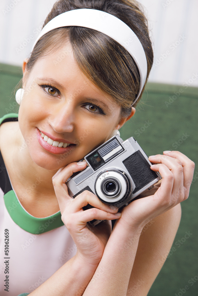 Retro woman with old-fashioned camera