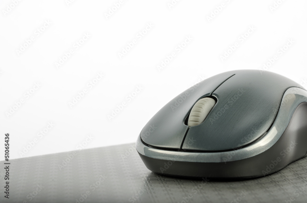Wireless computer mouse on a metallic background Wireless computer mouse on a metallic background