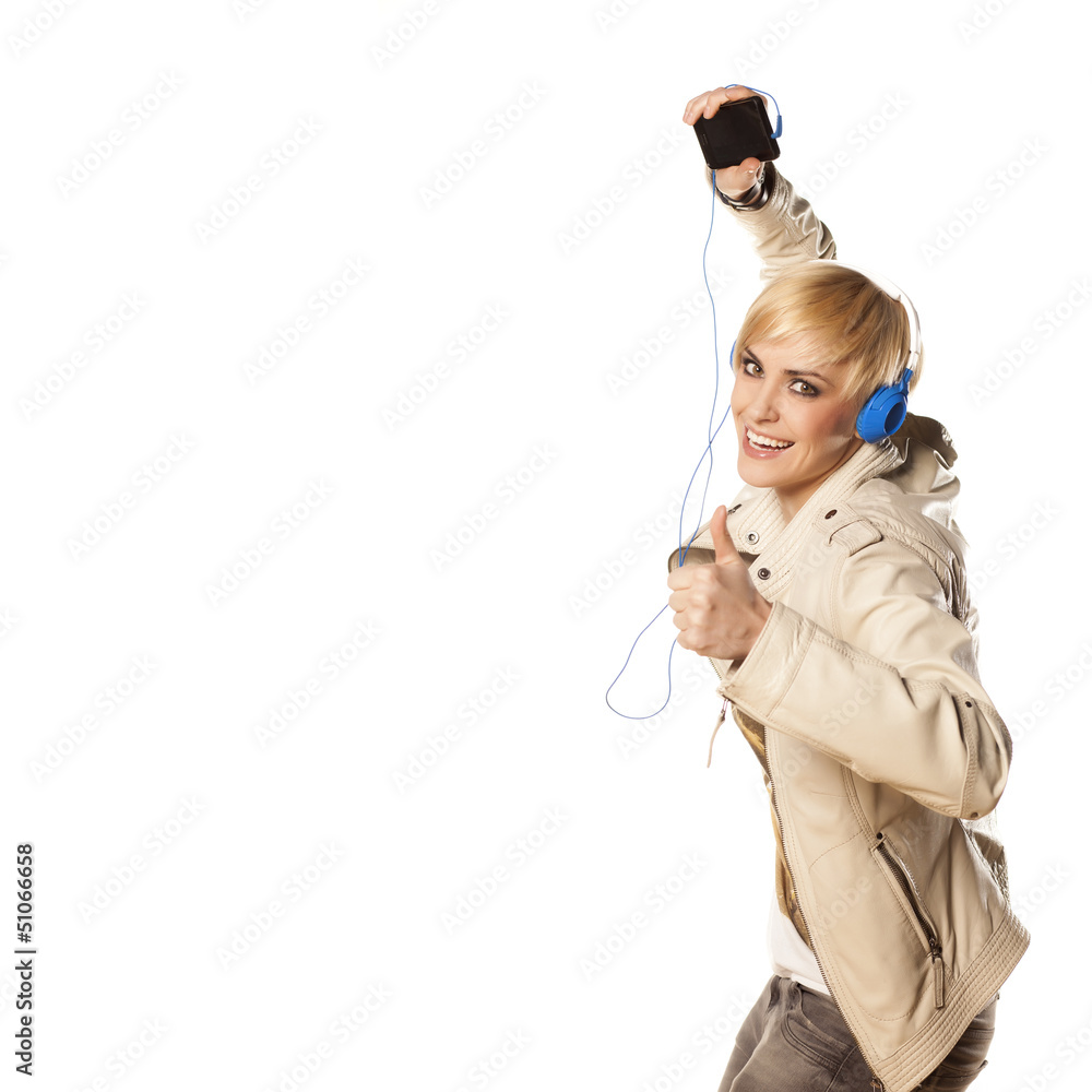 blonde plays with headphones and music from her phone blonde plays with headphones and music from her phone