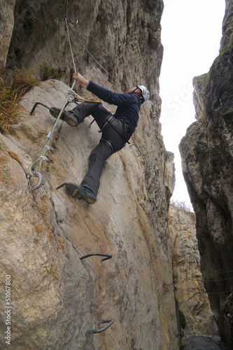A hiker on the via ferrata of Chianocco ( Italy )