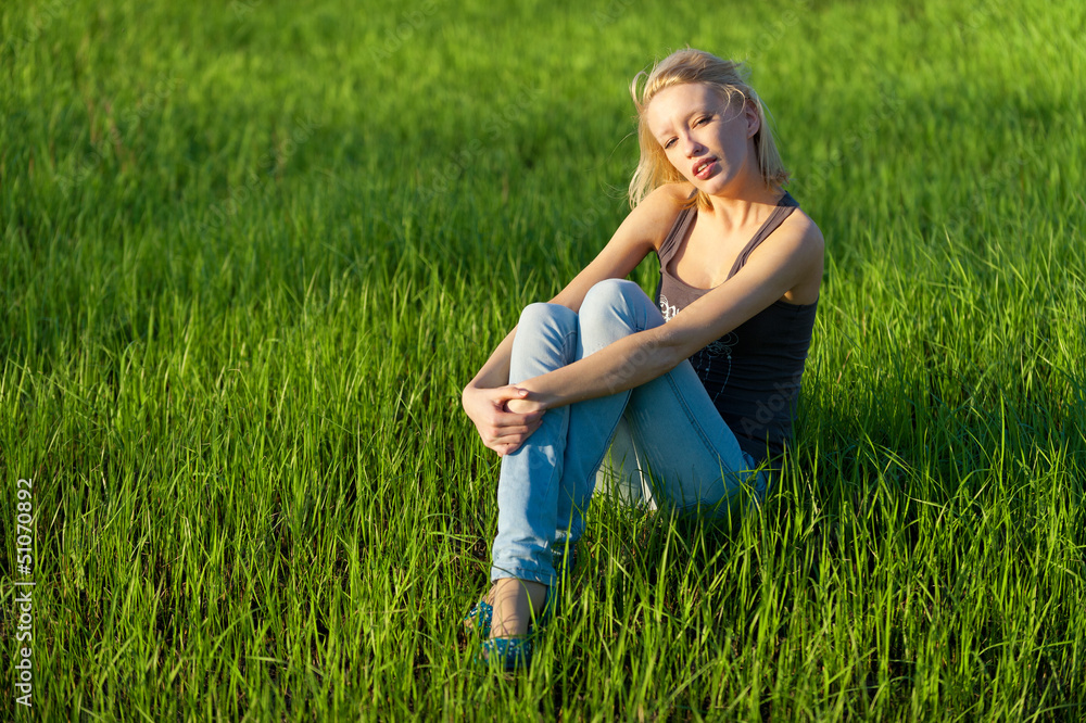 Fototapeta premium Portrait of the young beautiful blond woman outdoors