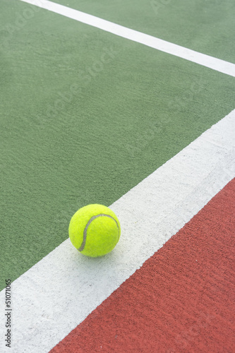 Tennis ball on the white line.