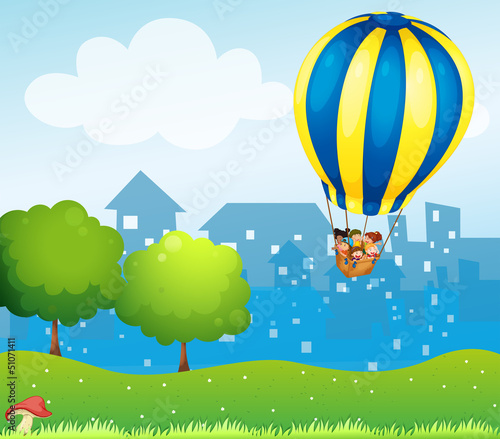 A big hot air balloon above the hill