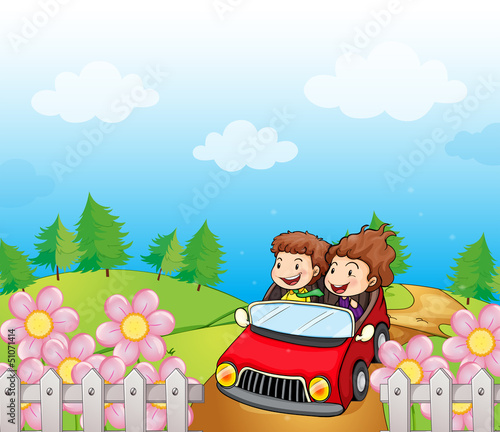 A red car with a young girl and boy