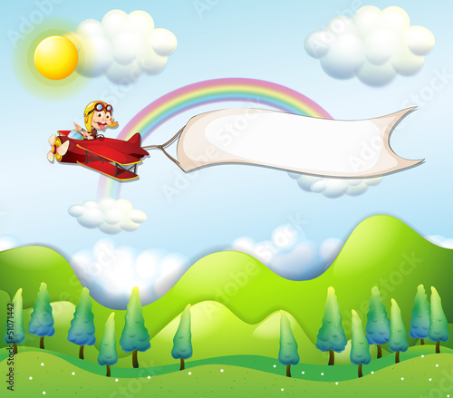 A monkey riding in a red airplane with an empty banner