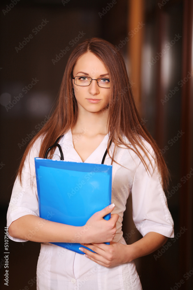 Beautiful female doctor in hospital corridor Beautiful female doctor in hospital corridor
