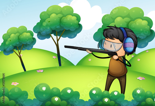 A man with a long gun at the top of the hill