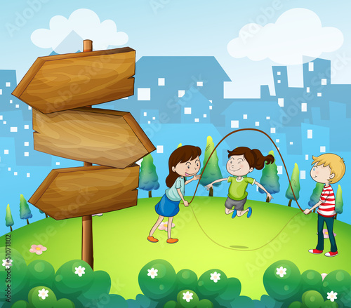 Three kids playing in the garden with wooden arrows
