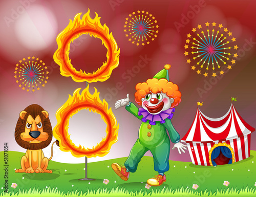 A carnival with a clown and a lion near the ring of fire