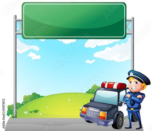 A policeman with his patrol car near the signage