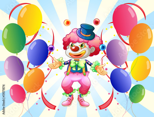 A clown with a colorful costume surrounded by balloons
