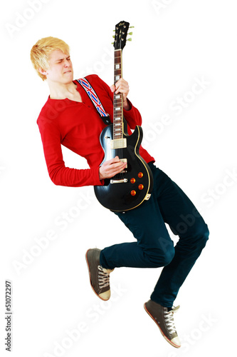 Young man playing guitar jumping