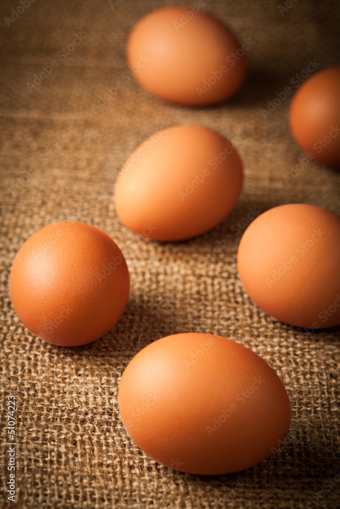 many hen eggs on burlap background many hen eggs on burlap background