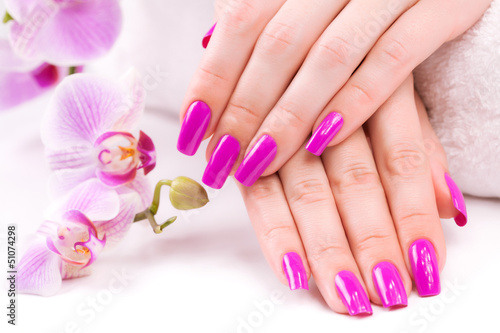 beautyful manicure with fragrant orchid and towel. Spa