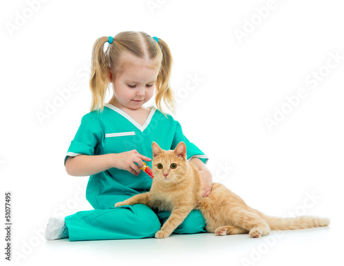 Cute kid girl playing doctor with cat isolated