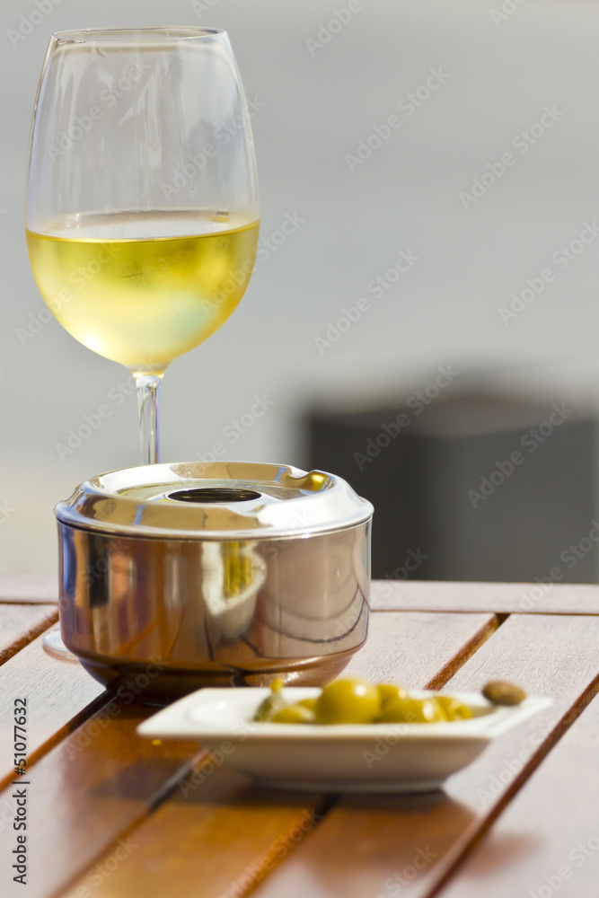 White wine, ashtray and olives White wine, ashtray and olives