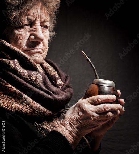 portrait of an old woman with Argentinean calabash in hands