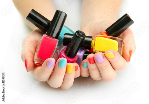 woman hands with nail polishes isolated on white photo