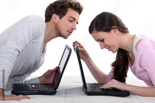 Man stealing a glance at his neighbour's laptop photo