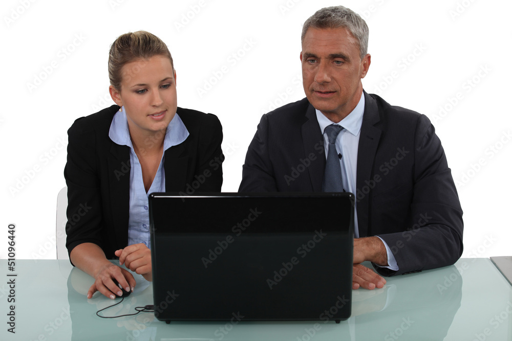 A team of business professionals reading an e-mail A team of business professionals reading an e-mail