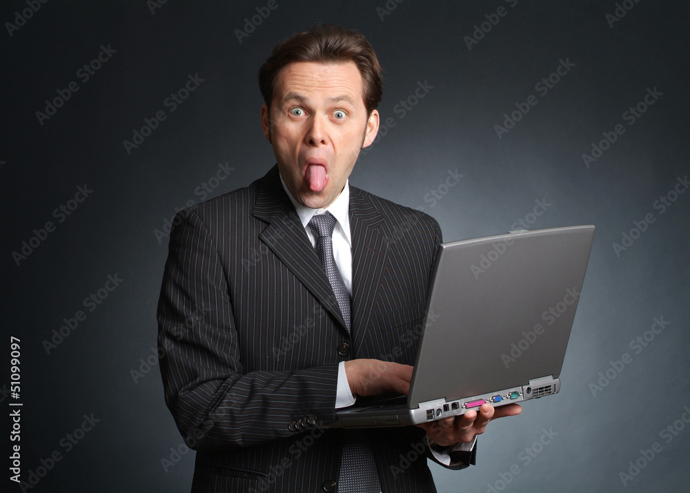 Businessman with laptop streching out his tongue Businessman with laptop streching out his tongue