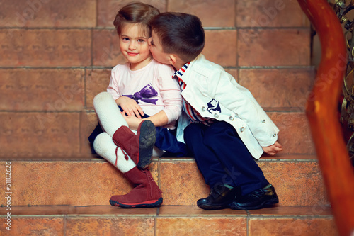 little gentleman kisses girl photo