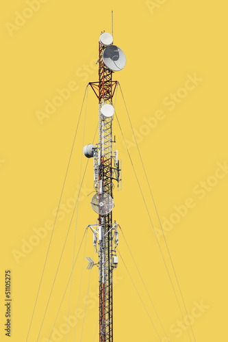 Telecommunications tower with radio and telephone antennas and satellite dishes on white background.