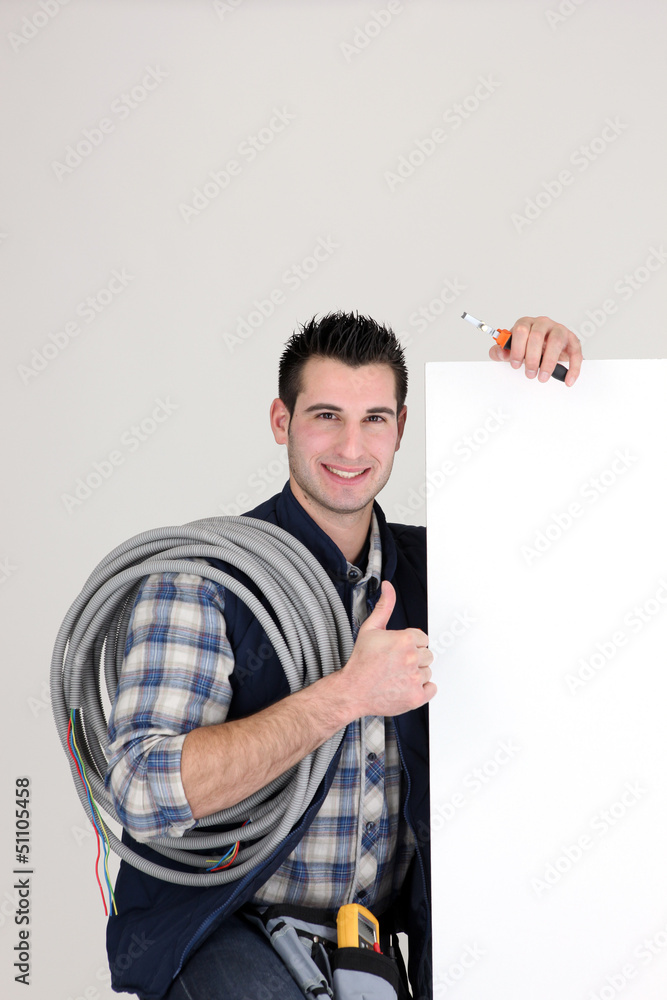 Thumbs up from an electrician with a blank board Thumbs up from an electrician with a blank board