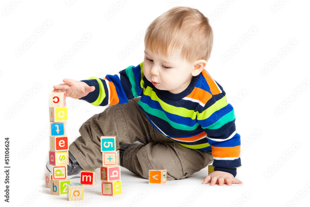 baby playing with wooden toy cubes with letters. Wooden alphabet baby playing with wooden toy cubes with letters. Wooden alphabet