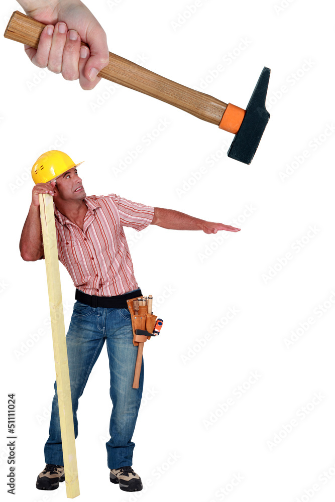 Construction worker being hit with a hammer Construction worker being hit with a hammer