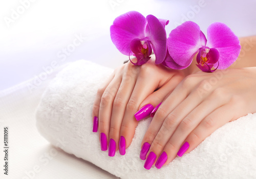 beautiful manicure with pink orchid and towel