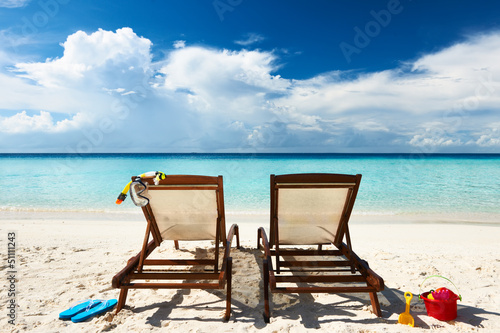Tropical beach with chaise lounge Fototapeta