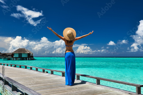 Woman on a beach jetty at Maldives © haveseen