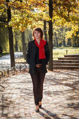 beautiful girl is in autumn in the park