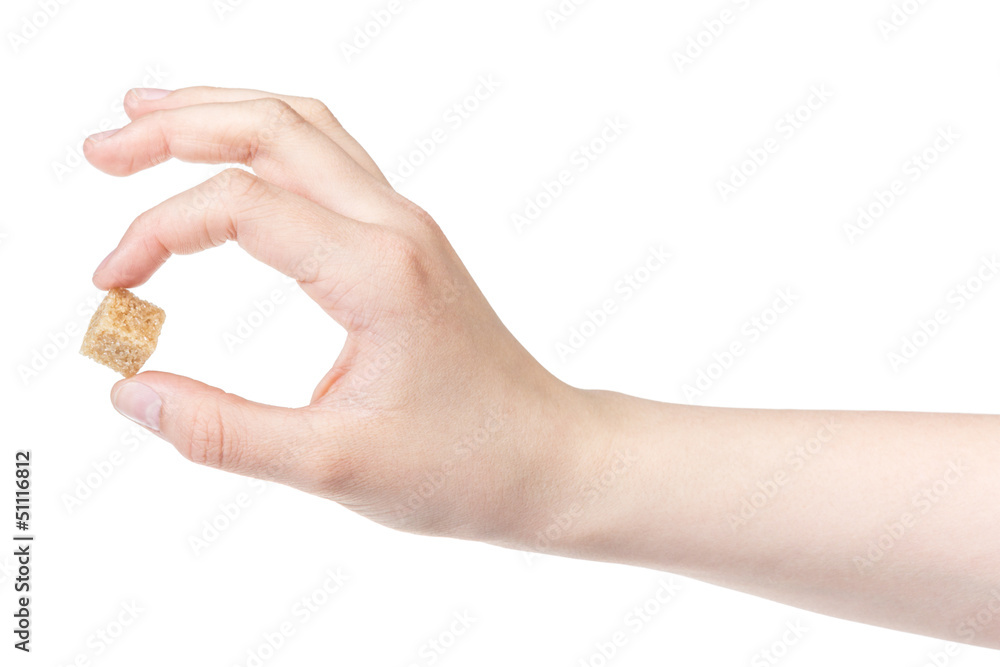 female teen hand holding cube of sugar female teen hand holding cube of sugar