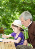 Grandfather spending time with little girl outside