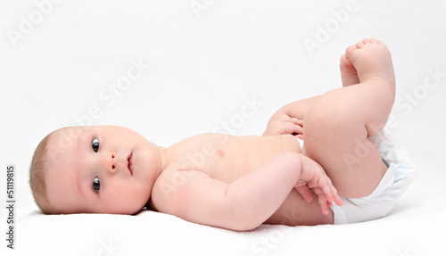 Beautiful baby lies on back