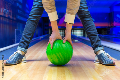 Beginner aiming to bowling pins