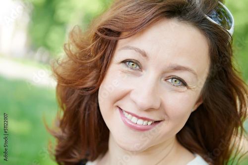 Smiling adult woman at spring outdoors