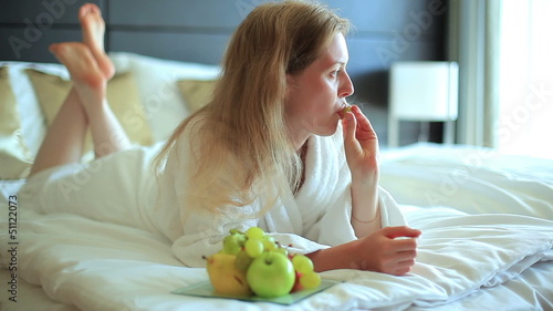Young woman eating fruits.