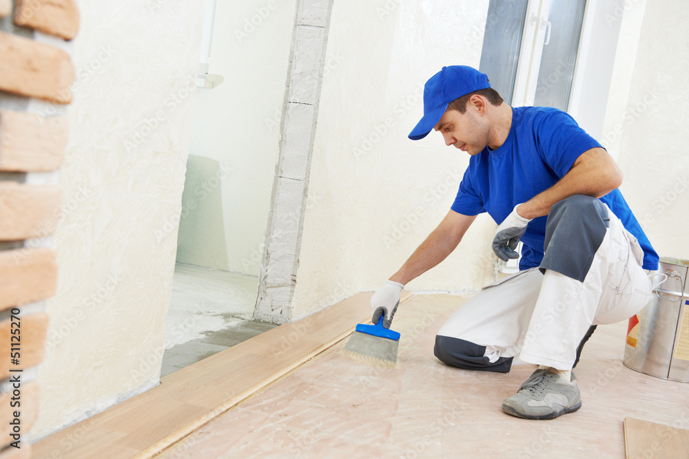 parquet worker adding glue on floor parquet worker adding glue on floor