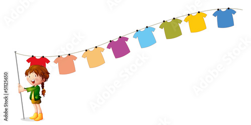 A girl holding a stick with hanging clothes