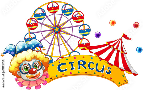 A clown beside a circus signboard