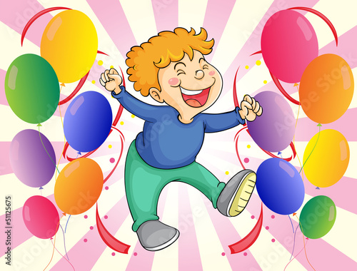 A boy jumping with balloons at his side