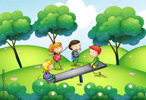 A group of kids playing at the top of the hill