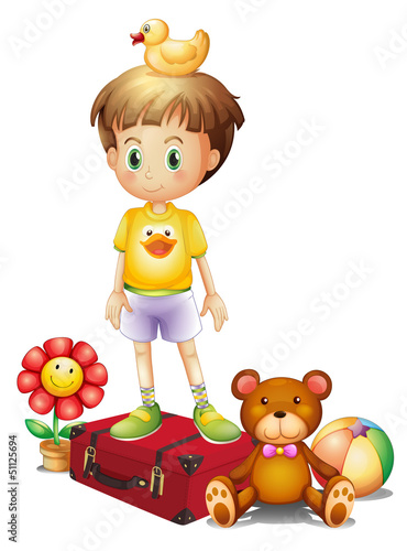 A boy above the red box with his different toys