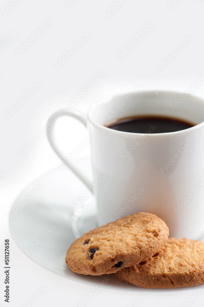 A cup of coffee with some cookies on white background A cup of coffee with some cookies on white background